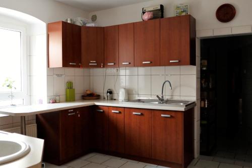 a kitchen with wooden cabinets and a sink at Dom prywatny in Przesieka