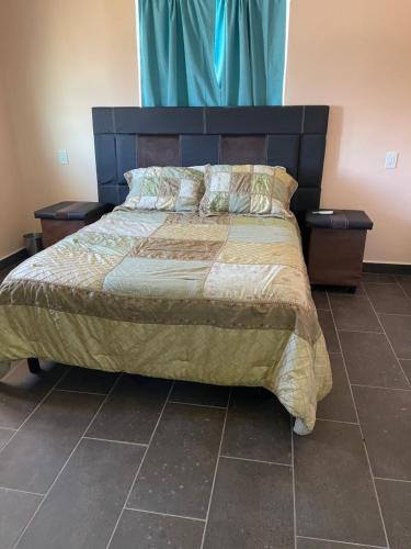 a bedroom with a large bed with two night stands at Condominio puerto peñasco in Puerto Peñasco