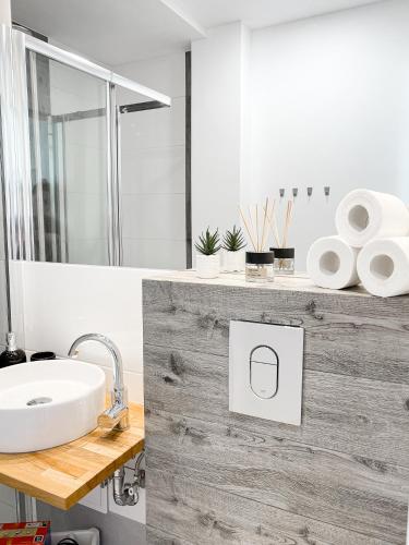a bathroom with a sink and a shower at COCO Apartments Jagiellońska 10 in Gdańsk