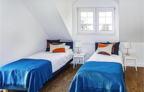 two beds in a room with blue and white at Amazing Home In Silec With Sauna in Srokowo