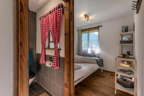a small room with a bed and a window at Florin Ferien in Klosters