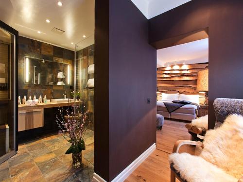 a bathroom with a sink and a bed in a room at Hesselby Slott in Stockholm