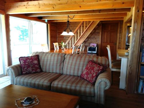 a living room with a couch and a table at Hana Mana in Yakushima