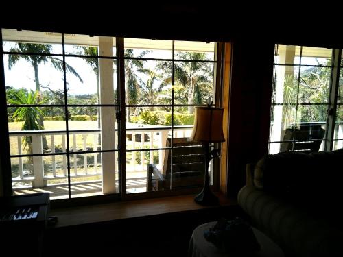 a room with a window with a view of a balcony at Hana Mana in Yakushima