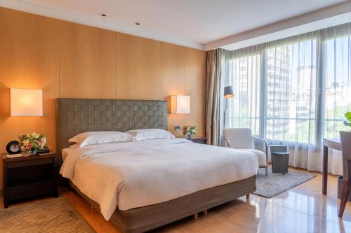 a bedroom with a large bed and a large window at Palacio Duhau - Park Hyatt Buenos Aires in Buenos Aires