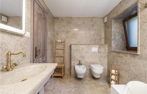 a bathroom with a tub and a toilet and a sink at Awesome Home In Kornic With Kitchen in Kornić