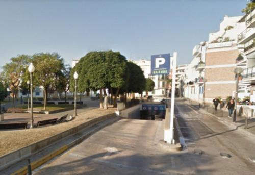 a street in a city with buildings and a parking lot at Bo&Co Apartments in Sitges