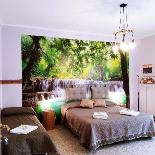 a bedroom with a waterfall mural on the wall at Miralago View in Revine Lago