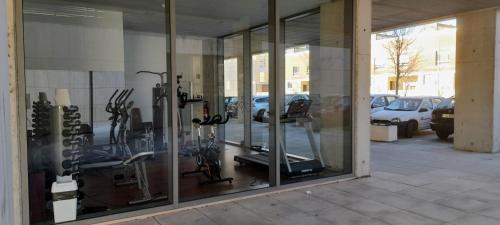 a store front with glass windows and bikes in a parking lot at Ria Palace Apartment in Aveiro
