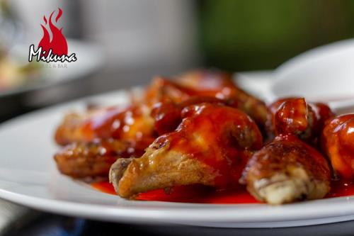 a plate of food with chicken covered in sauce at Arhaná Hosteria & Resort in Gualaceo
