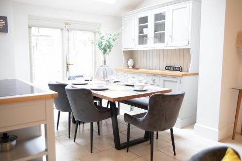 a kitchen with a dining room table and chairs at 35 Grosvenor Terrace - 3 Bed Sleeps 6, 5 min walk from York City Centre in York