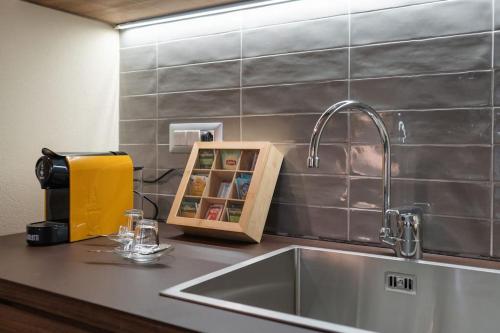 a kitchen counter with a sink and a faucet at Recinto Nobili 1-private parking su richiesta in Asti