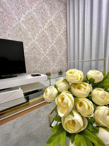 a bouquet of yellow roses in a living room at Funchal Lido View 1 in Funchal