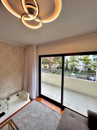 a living room with a large sliding glass door at Funchal Lido View 1 in Funchal