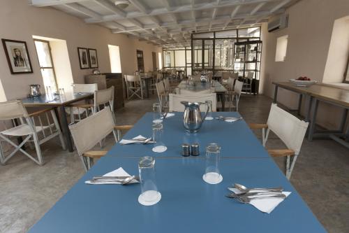 a dining room with a blue table cloth on a table at Azraq Lodge in Al Azraq ash Shamālī