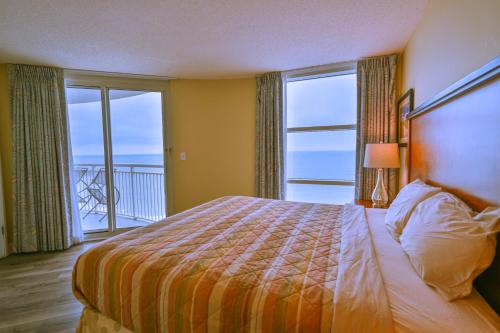 a bedroom with a bed with a view of the ocean at Gorgeous Condo 3 Br 3 Balconies SB 11th Floor in Myrtle Beach