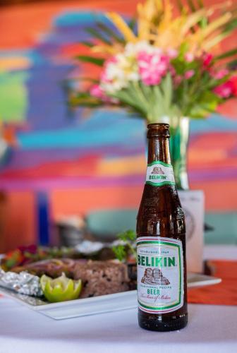a bottle of beer sitting on a table with a plate of food at Captain Morgan's Retreat in San Pedro