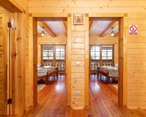 a room with wooden walls and wooden floors and tables at Апарт-Готель "Панщина" in Slavske