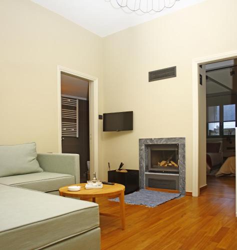 a living room with a couch and a fireplace at Kazas Luxury in Dhimitsana
