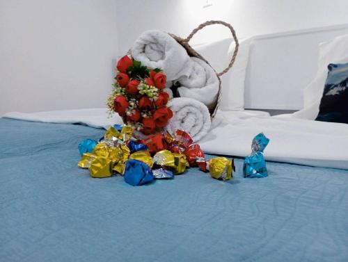 a bed with a pile of flowers and a pile of towels at Nautilus City Studios & Apartments in Rhodes Town