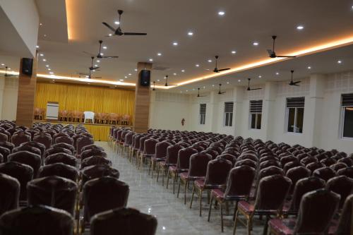 an empty room with rows of chairs in it at HYDEPARK REGENCY in Palakkad