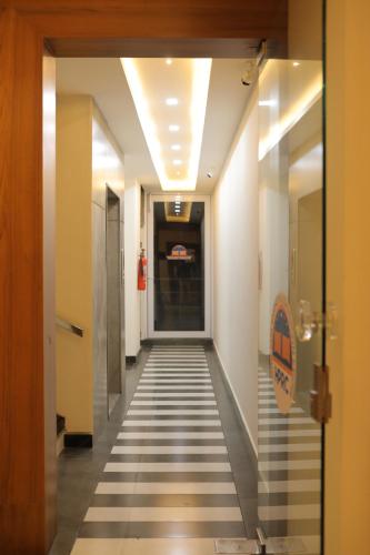 a hallway with a tile floor in a building at HYDEPARK REGENCY in Palakkad