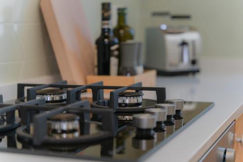 a close up of a stove top with bottles of wine at Tiny house in the historic centre of Soverato in Soverato Superiore