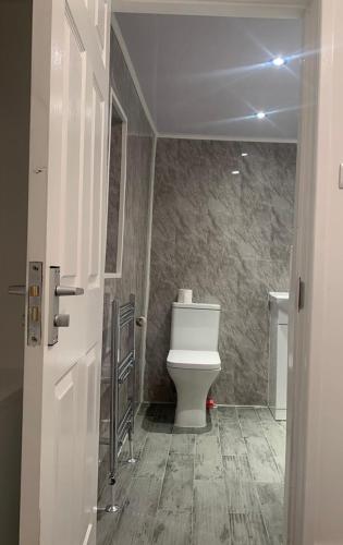 a bathroom with a toilet and a sink at Home away from Home in Liverpool