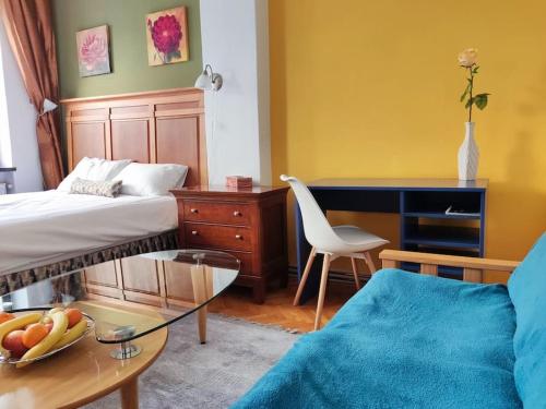 a room with a bed and a desk and a chair at Bascarsija apartment B-Home Old Town Sarajevo in Sarajevo