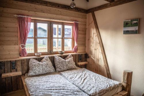 a bedroom with a bed and a window at Urlaub am Erlebnishof Strasser 