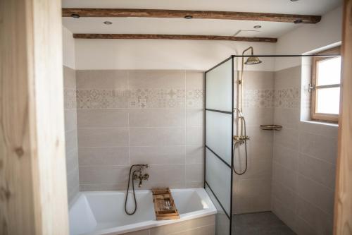 a bathroom with a tub and a shower stall at Urlaub am Erlebnishof Strasser in Ebergersch
