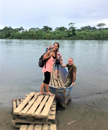 a group of people standing on a boat in the water at Terra NaturaMa - off grid living in the jungle in Punta Uva