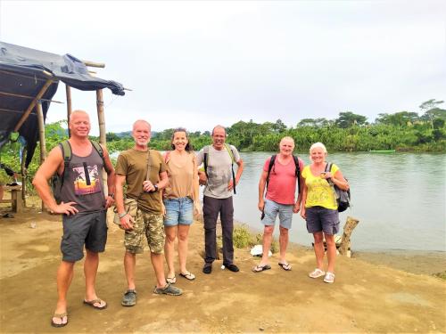 a group of people standing next to a body of water at Terra NaturaMa - off grid living in the jungle in Punta Uva
