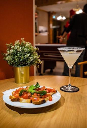 a plate of food on a table with a drink at Atmosphere Hotel in Les Deux Alpes