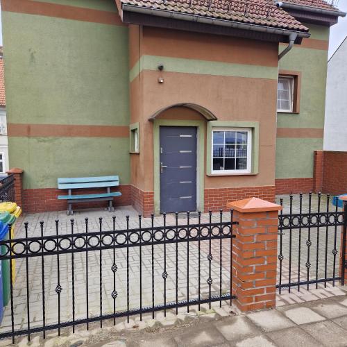 a house with a blue door and a bench at ewja 3 in Sulęcin