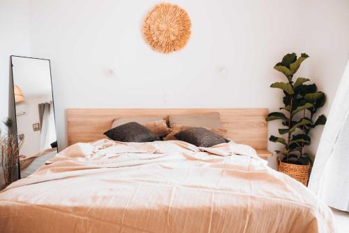 a bedroom with a bed with pillows and a mirror at Indigo Seaside Experience in Adelianos Kampos