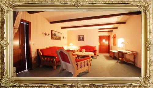 a picture of a living room with a table and chairs at Landhaus Hotel Romantik in Gotha