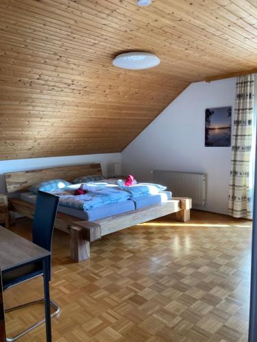 una camera da letto con un letto e un soffitto in legno di Körners Ferienwohnung am Fuße des Voithenbergs a Furth im Wald