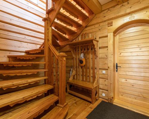 a wooden cabin with a staircase and a door at Апарт-Готель "Панщина" in Slavske