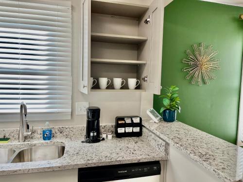 a kitchen with a sink and a counter top at Plush Downtown ATL 2BD Home w/ FREE PKNG in Atlanta