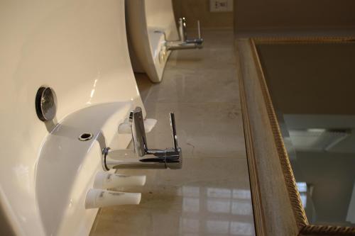 a bathroom with a sink and a mirror at Cu Guest House in Phalaborwa