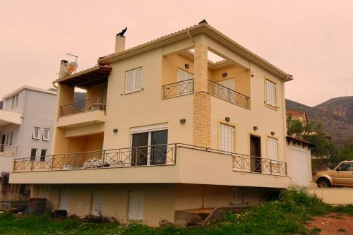 a building with balconies on the side of it at Rural 3-bedroom house Kalamata in Kalamata