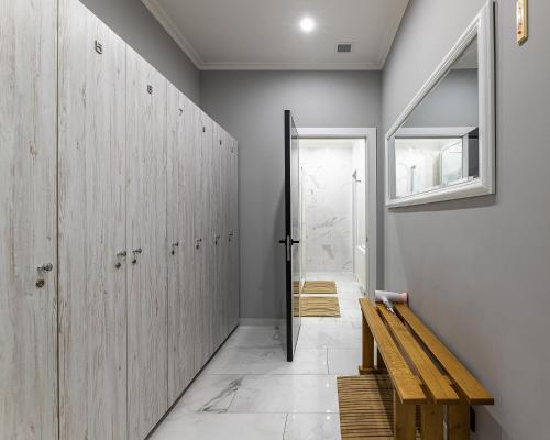 a hallway with wooden lockers and a wooden bench at Апарт-Готель "Панщина" in Slavske