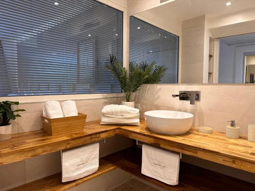 a bathroom with a sink and a large mirror at Curaçao 13 studio vue mer proche plage dans Complexe type Village Vacances in Sainte-Luce