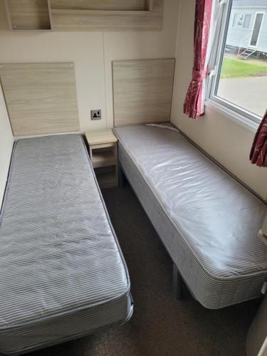 A bed or beds in a room at Seawick Holiday Park