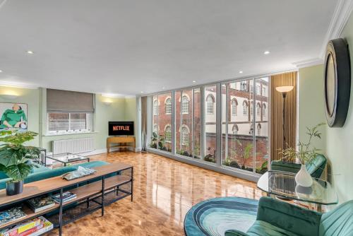 a living room with a couch and a table at Stylish Apartment Near Norwich Cathedral & Castle in Norwich