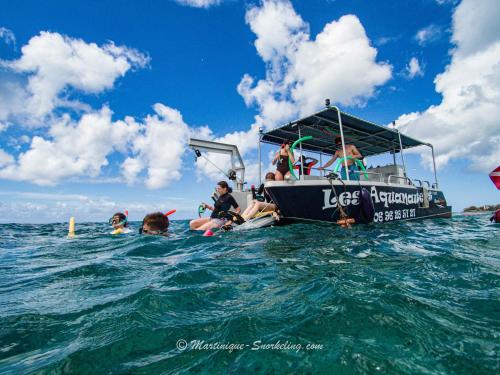 a group of people on a boat in the water at Curaçao 13 studio vue mer proche plage dans Complexe type Village Vacances in Sainte-Luce