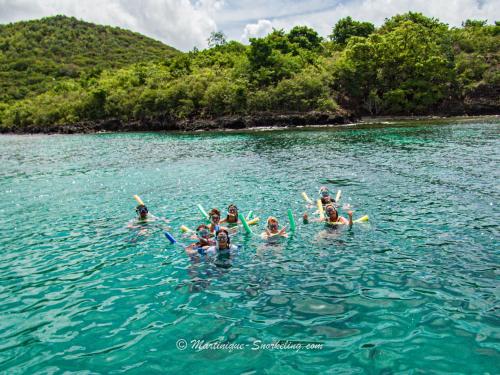 a group of people swimming in the water at Curaçao 13 studio vue mer proche plage dans Complexe type Village Vacances in Sainte-Luce