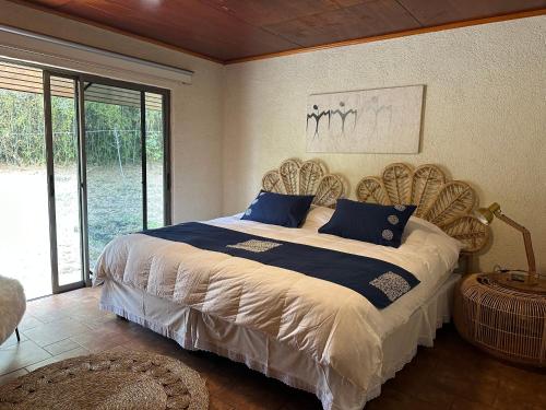 a bedroom with a large bed with a large window at Hare Paoa Lodge Boutique in Hanga Roa