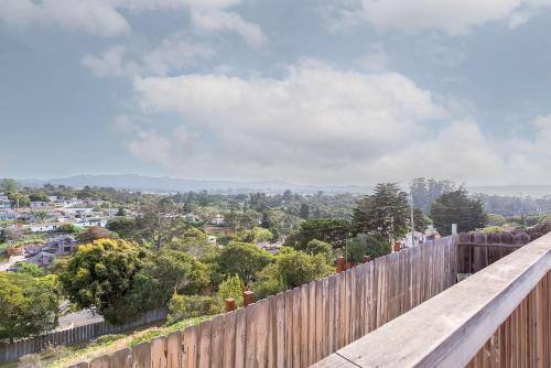 a wooden fence with a view of a city at 3849 La Vista Portola home in Del Rey Oaks